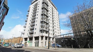 A tall, multi-story residential building with balconies and a flat roof. - The Cardiff Apartment (Cardiff)