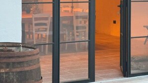 A room with a large sliding glass door leading to an outdoor area. - Charming masseria fully renovated in 2024  (Monopoli)
