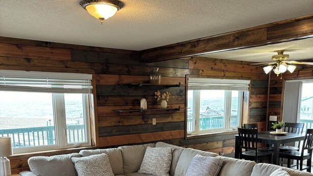 A cozy living room with a sectional sofa, a small table, and a ceiling fan. - "Ackerman Lakeside" - 3 Story, 4 Bed, 3 Bath (South Minnewaukan)