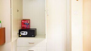 A small, white cabinet with a hair dryer and a box on top. - City View with Rooftop pool Studio (Nairobi)