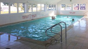 An indoor swimming pool with clear depth markers, a tiled floor, and a metal pool ladder. - Lochside Retreat at Three Lochs Holiday Park (Newton Stewart)