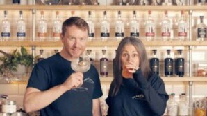 A bar with shelves of bottles and a sign that reads "GIN BAR". - Central Ellesmere -sleeps2 - Parking - Petfriendly (Ellesmere)