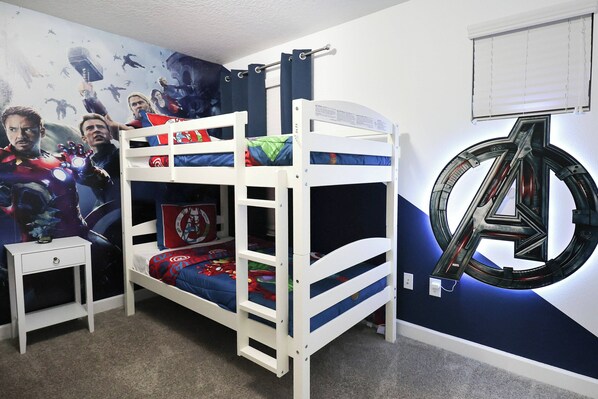 A bunk bed with a superhero-themed wall mural and a large 'A' logo. - Themed 5BD Home, Movie and Game Room (4726) (Kissimmee)