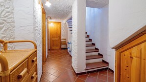 A staircase with white walls and wooden steps leading to a door. - Gian s Home by Wonderful Italy (San Teodoro)