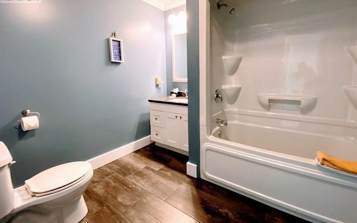 A bathroom with a toilet, sink, and bathtub.