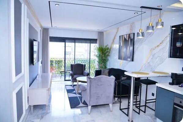 Relax in a stylish room with a seating area, bar, and large window offering a view of the outdoors.