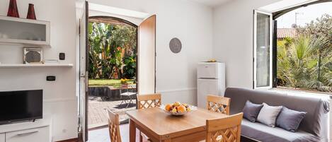 Apartment, Garden View | Living area | 35-inch TV with digital channels, fireplace