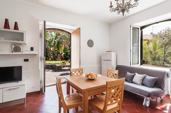 Apartment, Garden View | Living area | 35-inch TV with digital channels, fireplace - City Cottage with Garden & Pool (Catania)