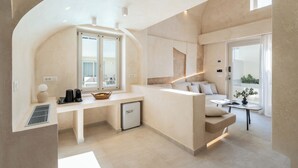 Une cuisine moderne dotée d’un îlot central intégré, d’un coin repas avec un canapé et d’une vue sur l’extérieur.