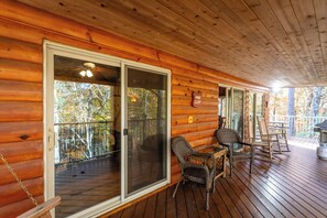 A wooden cabin with a covered porch, sliding glass doors, wicker chairs, and a sign indicating 'Pine Cliff'. - Castle Cliff Riverfront Cottage Peaceful Private Less than15 min to Harrisonburg (Hinton)
