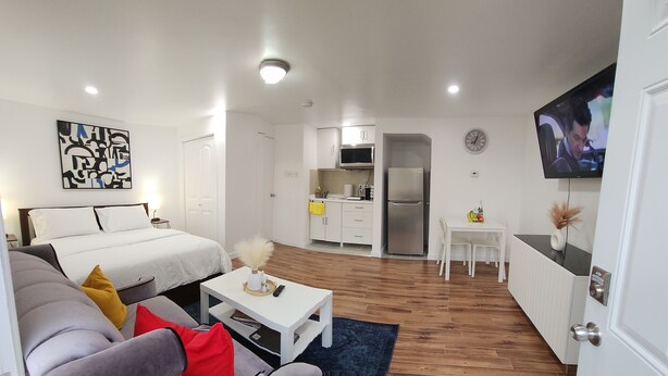 A modern, compact living space with a bed, sofa, and kitchenette. - Studio Room in Halifax (Halifax)