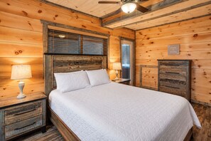 A wooden room with a bed, nightstands, and a ceiling fan. - Free Dollywood Tix/DogsOK/10Min2Dollywood (Sevierville)