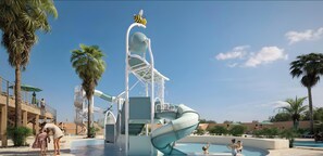 A water park with a large slide, palm trees, and a pool area. - Mobile Home '4-6 Personnes' with Shared Pool, Terrace and Air Conditioning (Argeles sur Mer)
