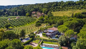 A large house with a swimming pool, surrounded by lush greenery and trees. - Montaleo by Interhome (Casale Marittimo)