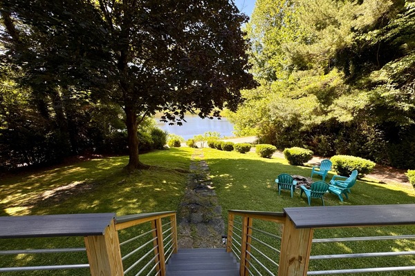 View of the lake with sets going down to the fire pit