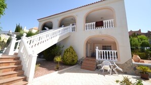 A two-story building with a white staircase, balconies, and outdoor seating. - Villa 'Casa Papa' with Private Pool, Private Terrace and Wi-Fi (San Fulgencio)