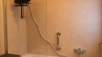 A bathroom with a bathtub, a shower, and a toilet.