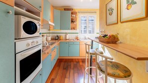 A kitchen with a microwave, oven, and wooden cabinets.