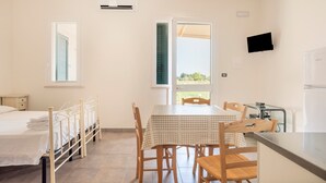 A bedroom with a bed, a bedside table, a window, and an air conditioning unit. - Apartment 'Muma 4' with Shared Terrace, Wi-Fi and Air Conditioning (otranto)
