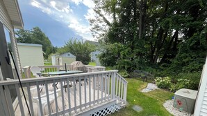 A deck with outdoor furniture, a covered table, and a grill. - Wells Charmer 2 Bed close to Wells Beach, Restaurants, AC, WiFi. 
Sleeps 6, Deck (Wells)