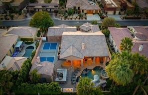 A residential area with multiple houses, a swimming pool, and a tennis court. - Ohana - Whale Slide, Arcade, Pickleball, Gym (Indio)
