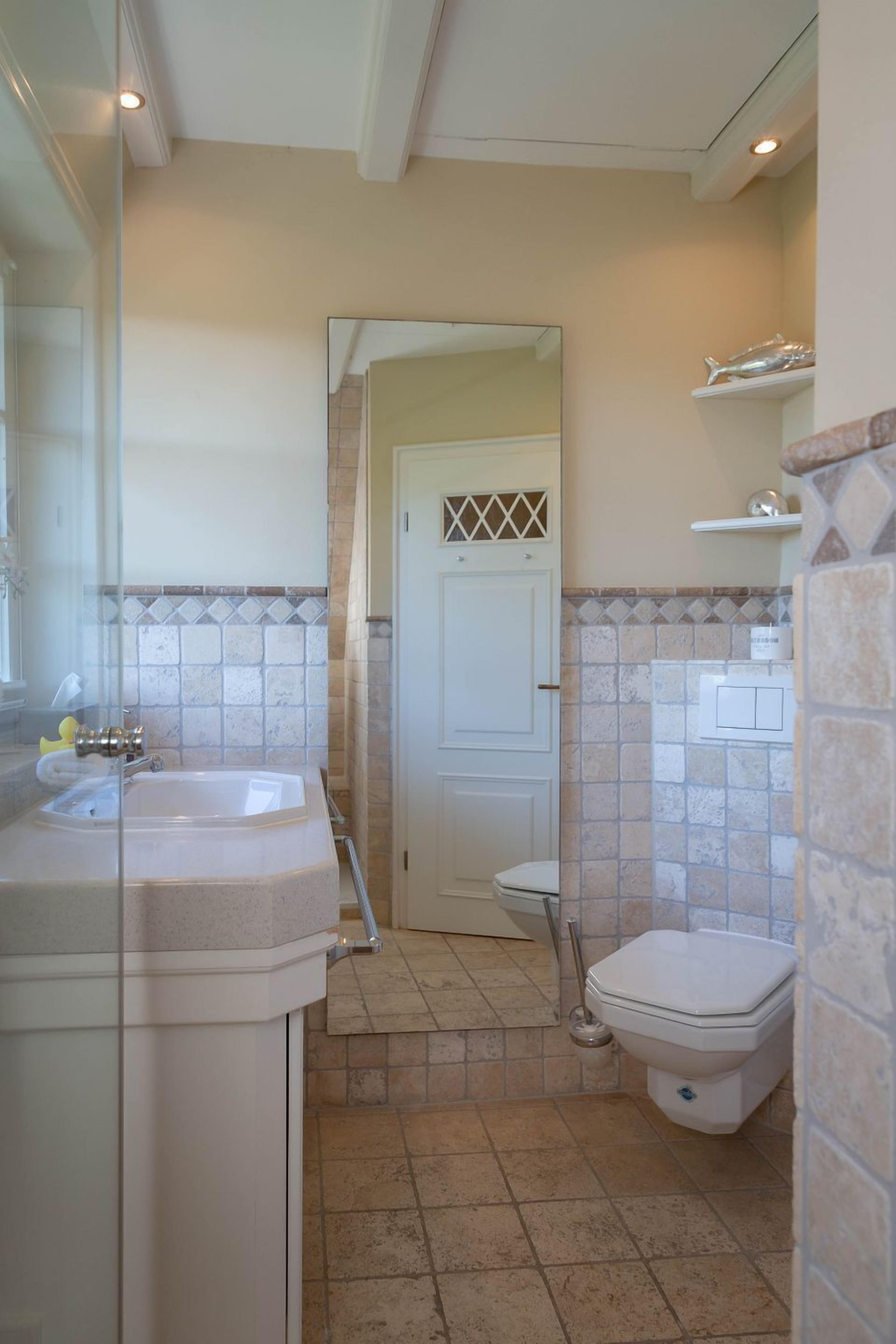 A bathroom with a bathtub, toilet, and sink.