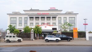 A hotel named "The Girvar" with a sign indicating "Sweets & Namkeen" and a "Rooms" sign. - The Girvar (Raipur)