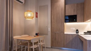 A modern kitchen with wooden cabinets, a microwave, and a coffee maker. - VLC HOST - Palau A (Valencia)