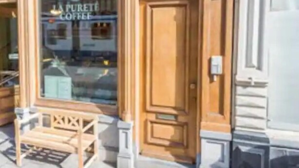 A storefront with a wooden facade and a large glass window displaying the name "LA PURETE COFFEE". - Room/private bathroom in centre (Amsterdam)