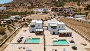 A resort with a pool area, multiple buildings, and a hilly landscape. - Thalelion Villa Private Pool and Jacuzzi (Naxos)