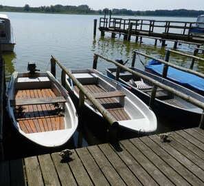 A wooden dock with several small boats docked.