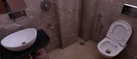 A bathroom with a sink, toilet, and shower.