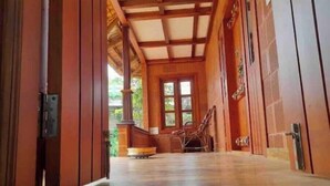 A wooden interior with a high ceiling and a large window.