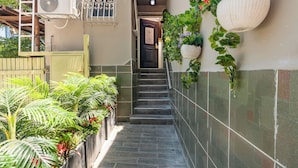 A narrow stairway with a tiled wall on one side and a metal gate on the other. - Chateau Tel Aviv (Tel Aviv)