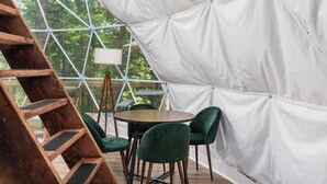 A tent with a wooden ladder, a round table, and green chairs. - Dream Dome - Romantic Retreat + Wifi A/C + Hot Tub (Luray)