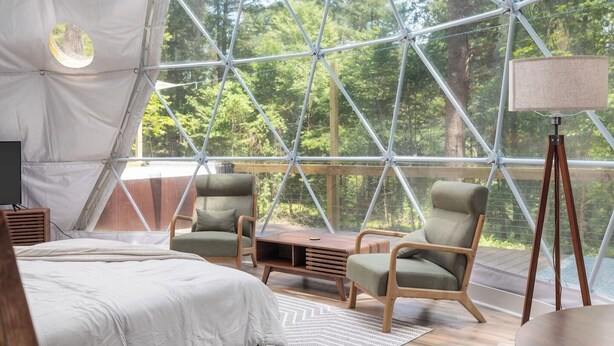 A tented room with a bed, two chairs, a table, and a lamp. - Dream Dome - Romantic Retreat + Wifi A/C + Hot Tub (Luray)
