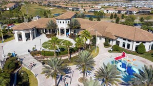 A residential area with a central courtyard, palm trees, and a swimming pool. - Modern 4Bed+PrivatePool Resort Style 8959 (Davenport)