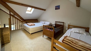 A bedroom with a loft bed, a crib, and a window. - Ski-In/Ski-Out Studio with Mezzanine, Balcony & Free Shuttle (Le Lioran)