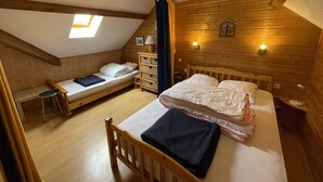 A cozy attic bedroom with a loft bed, a smaller bed, and a desk. - Cozy South-Facing Studio with Mezzanine, Near Slopes, Ski Shuttle, & Free Parking (Le Lioran)