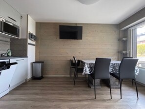 Enjoy meals in the kitchen with an oven, microwave, and coffee machine. Dine at the dining table with four chairs.