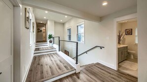 A staircase with wooden flooring, a handrail, and a door leading to a bathroom. - CL 874 Million Dollar View. Lake is now 100% full! (Canyon Lake)
