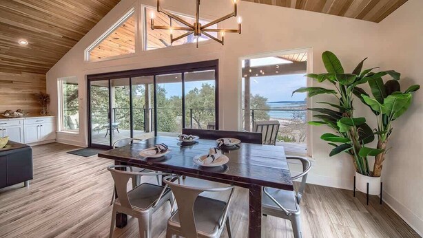 A spacious dining area with a wooden ceiling, large windows, and a view of the outdoors. - CL 874 Million Dollar View. Lake is now 100% full! (Canyon Lake)