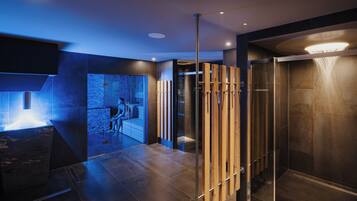 Bathroom features a glass shower enclosure and a vertical panel divider.