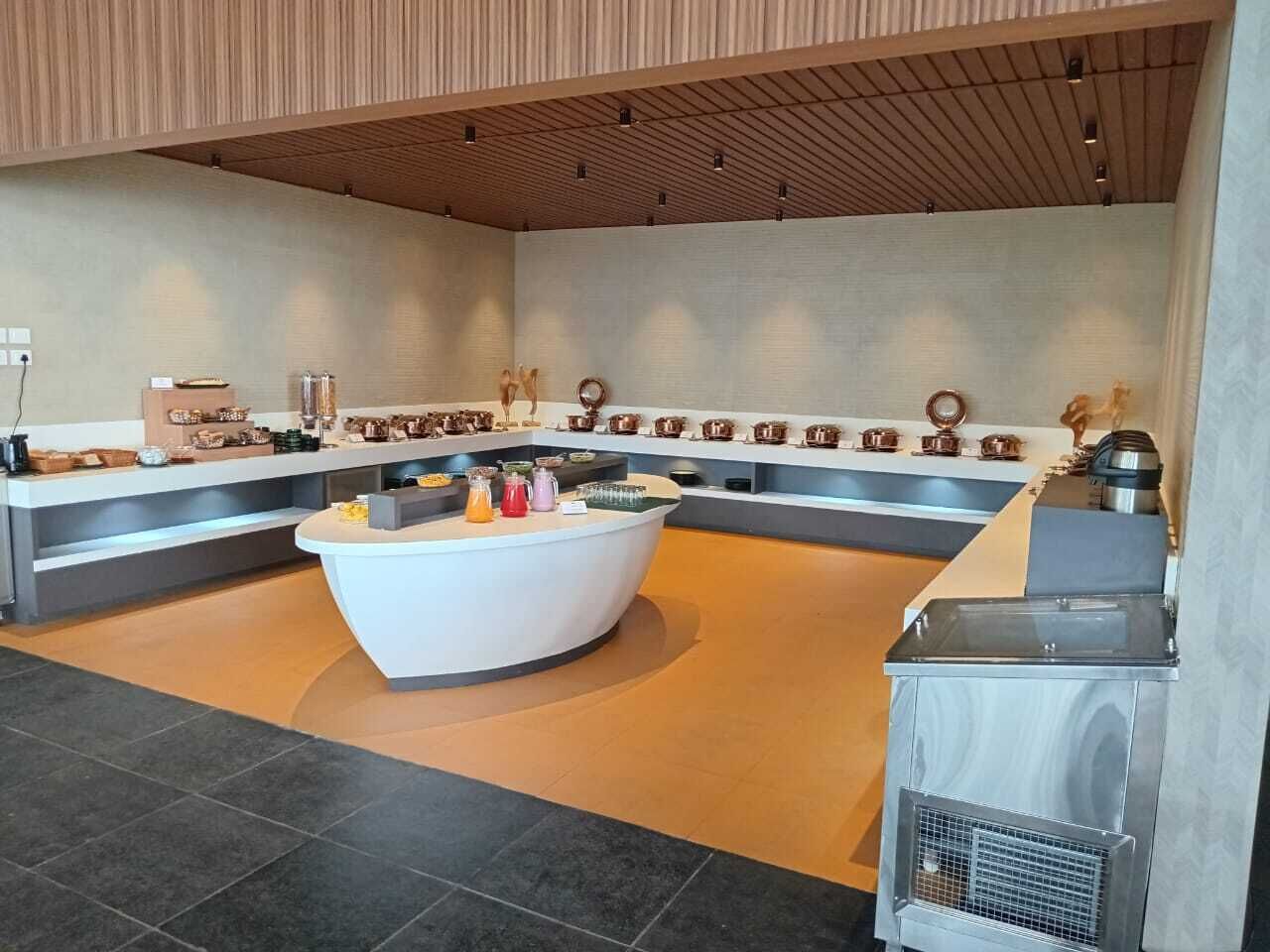 A modern kitchen with a central island, built-in appliances, and a variety of kitchenware.