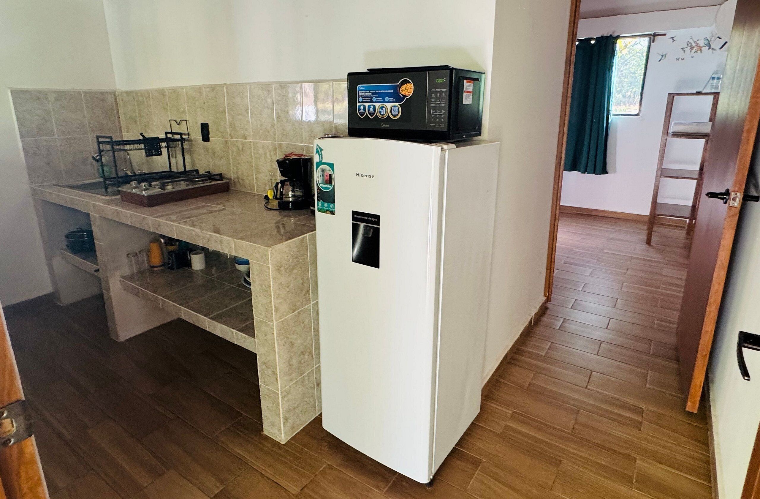 Fridge, microwave, coffee/tea maker, cookware/dishes/utensils