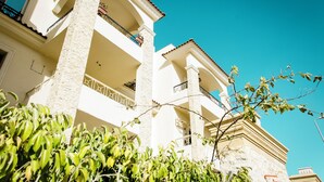 A multi-story building with balconies and a clear blue sky. - Violet 133 (New Cairo)