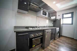 Full-size fridge, microwave, cookware/dishes/utensils