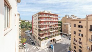 A multi-story building with balconies, a crosswalk, and parked cars. - Appartamento a due passi da Villa Trabia by Wonderful Italy (Palermo)