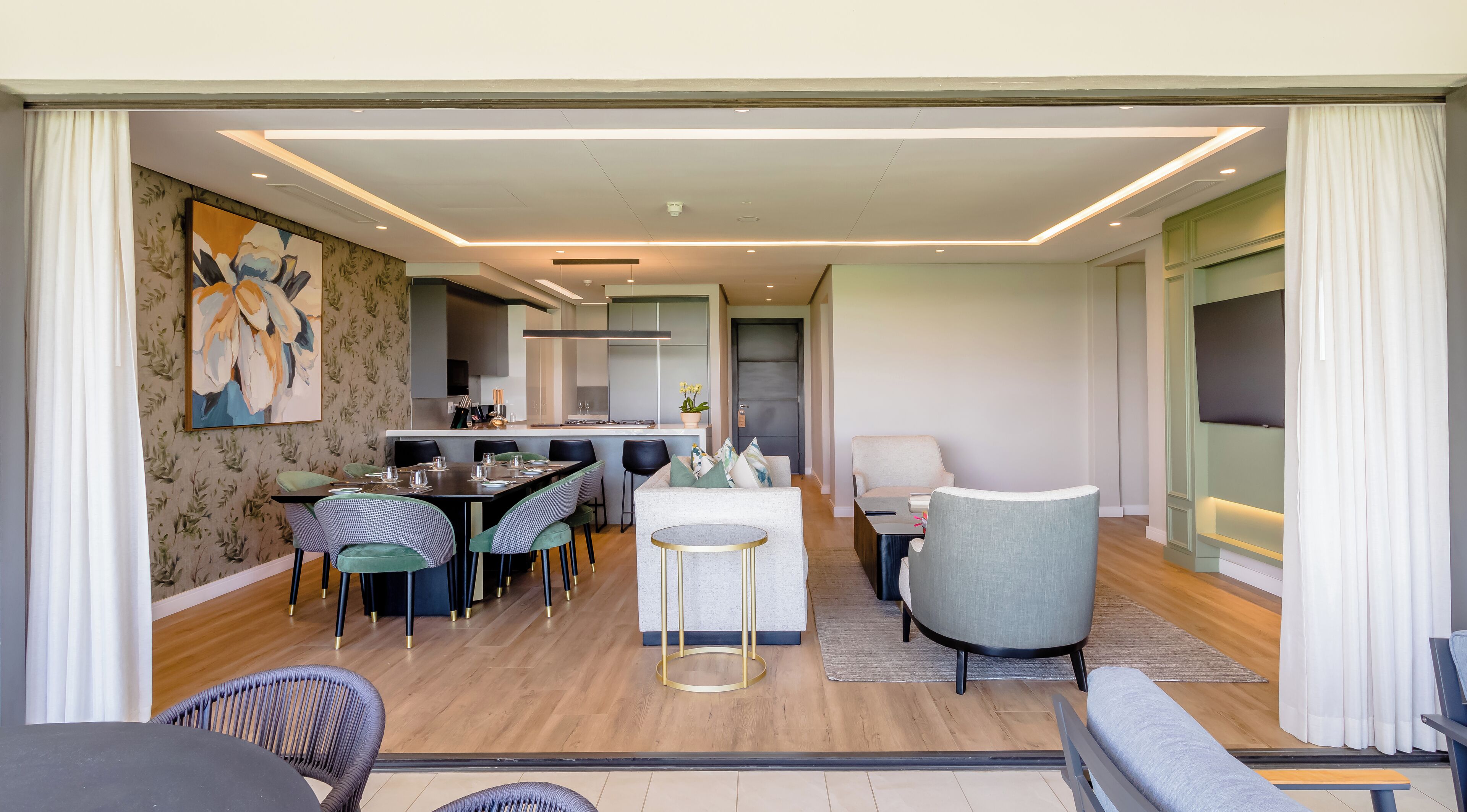 A modern interior with a dining area, kitchen, and seating space.