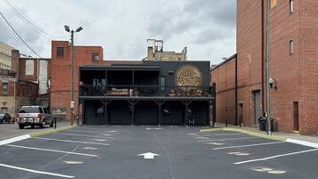 A parking lot with marked spaces and a building with a mural.